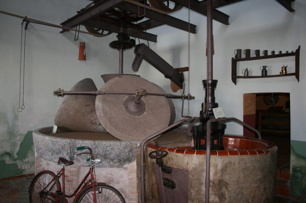 Interior of the La Almazara Museum, showing the tools and machinery once used to produce the renowned oil of this land.