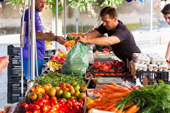 Image of a fruit and vegetable stand at a local produce market.