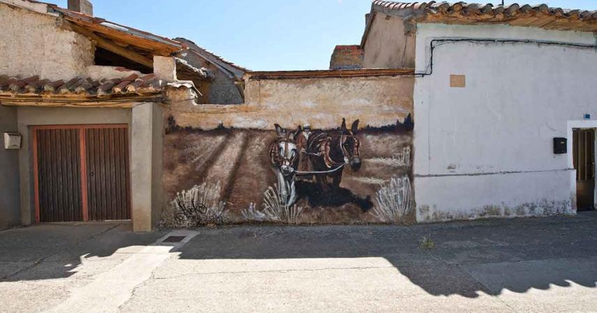 Peinture murale représentant un homme labourant avec deux mules